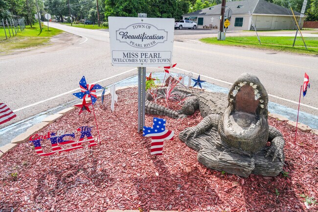 Miss Pearl, the town's beloved alligator statue, greets visitors with charm and a nod to the region’s swampy roots and playful spirit.
