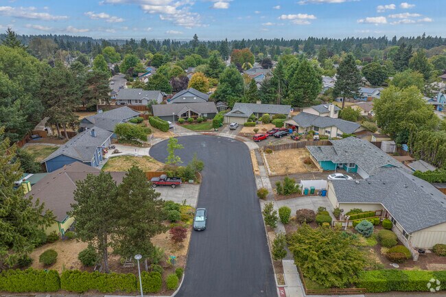 Tree-lined streets wind through Oakbrook near Meadowbrook Marsh Park in Vancouver.