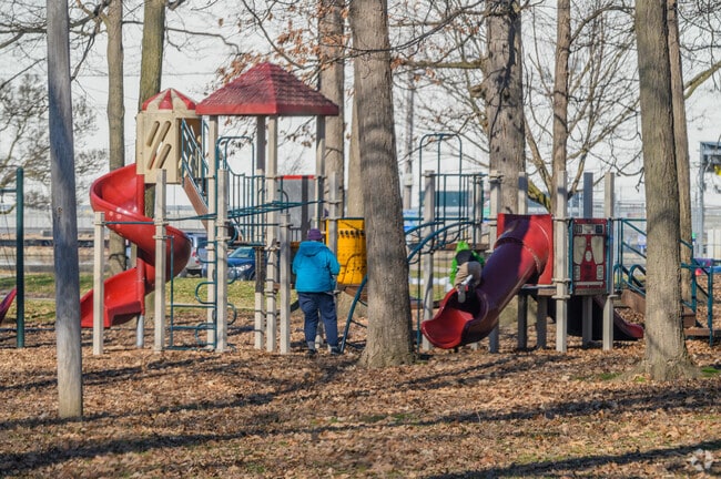 You can stop by the playground at Moores Park while bicycling along the Lansing River Trail.