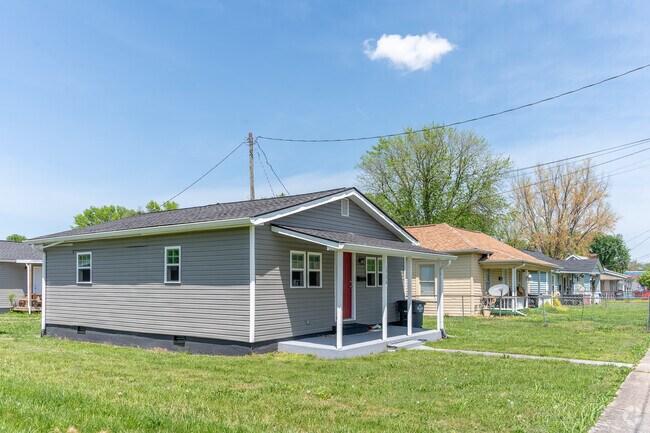 1950s-era homes with front porches and simple yards line up quiet streets in Highland Park.