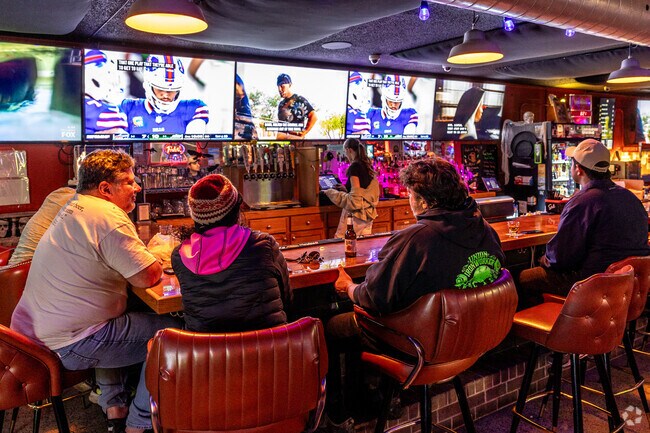 Jobsite patrons enjoy the company of friends and regulars while watching football.