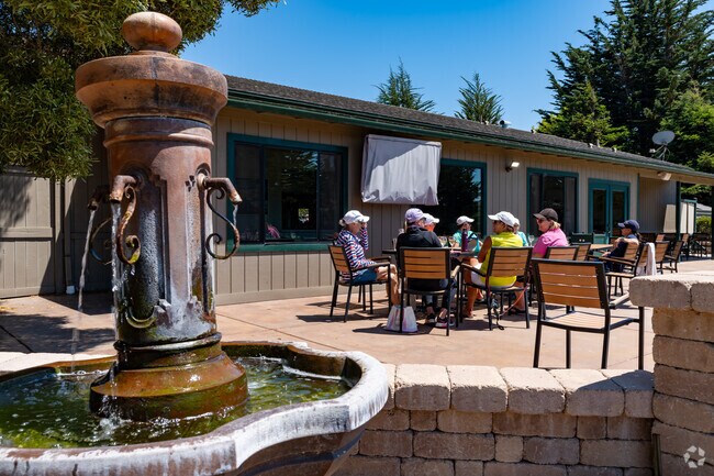 Lady golfers enjoy catching up on the patio after a round of golf at Cypress Ridge.