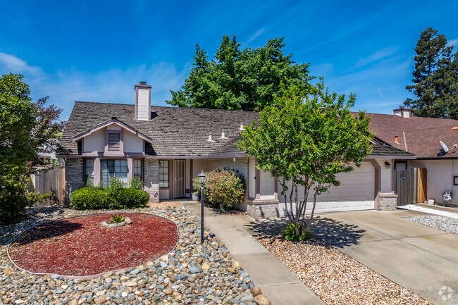 This single ranch-style home has an attractive front yard and shake roof in Florin.