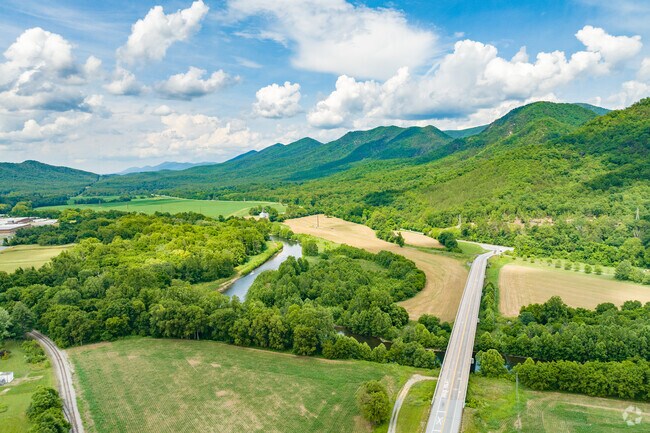 Natural Bridge features panoramic views of forested hills, ideal for outdoor exploration.