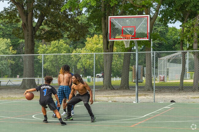 Friends gather at the basketball courts at Billy Gene Jackson Sr. Park for pick up games.
