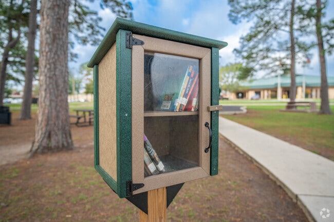 A mini library sits along a neighborhood sidewalk in Crosby, Texas.