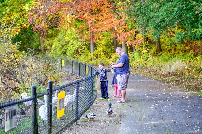A family enjoys feeding the birds at  the Kellogg Bird Sanctuary near South Gull Lake.