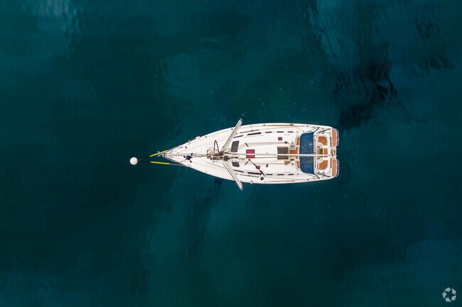 A quiet sailboat adds charm to the scenic Oyster Bay Cove shoreline.