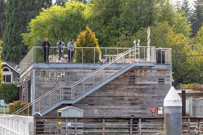 Three gentlemen overlook the harbor from Jerisich Public Dock in Gig Harbor.