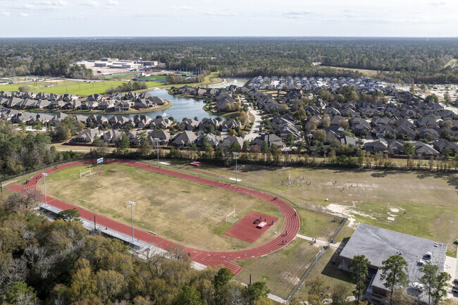 The football team at Woodridge Forest Middle School practices on the field adjacen to the school