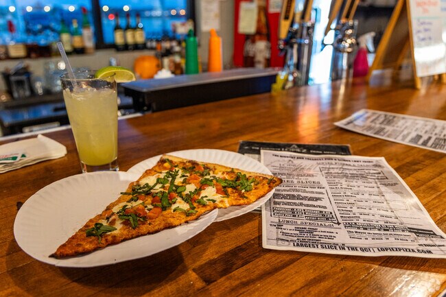 One plate is not enough to contain the biggest slices in Central Davenport at Lopiez Pizza.