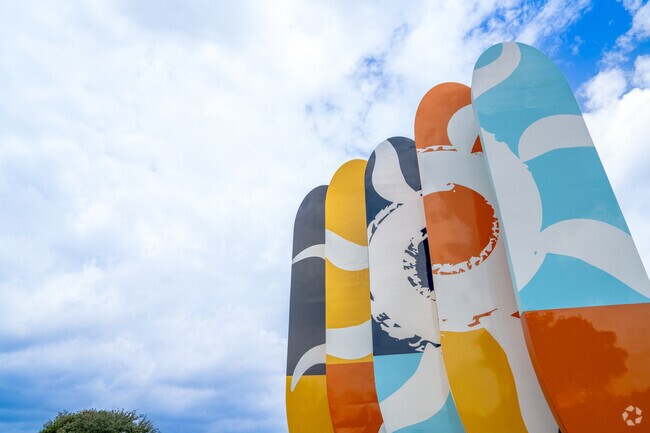 Surfboard artwork near Little Elm Beach reflects Paloma Creek South's 'take it easy' vibe.
