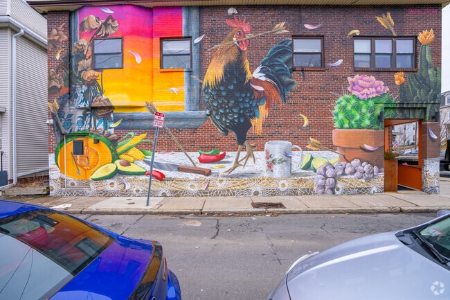 A colorful mural brightens the wall outside of Taco Laco in East Somerville.