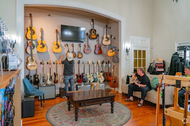 Friends try out guitars before purchase at the Music Connection near East Streets.