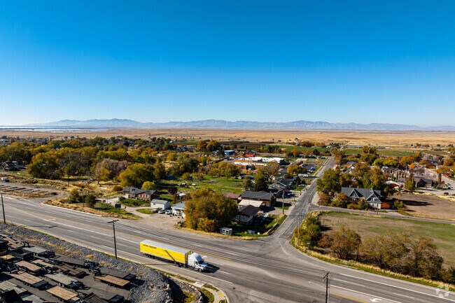 Highway 89 cuts through Perry’s orchards and suburbs with mountains in the distance.