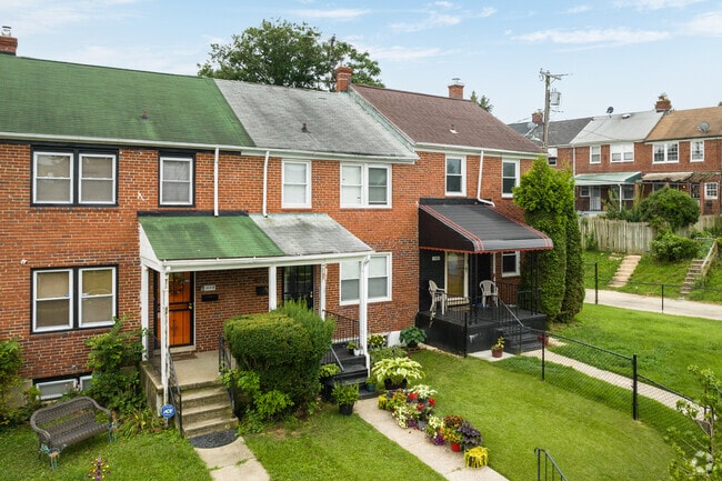 Short-roofed porches on red brick rowhomes are a common sight in Cameron Village.