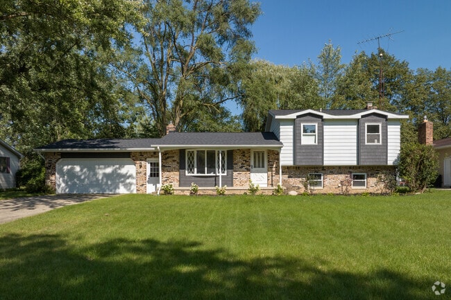 Split-level Ranch home with a tidy lawn in Reynolds Corners.