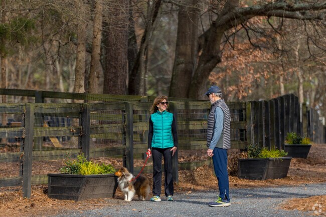 Walking the dog and chatting is a fun way to spend your afternoon at Wills Park in Alpharetta.