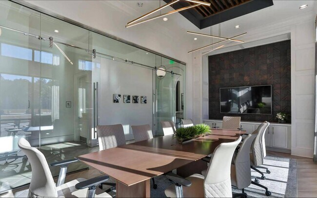 Resident Meeting Room with Rolling Chairs, TV, and Accent Wall
