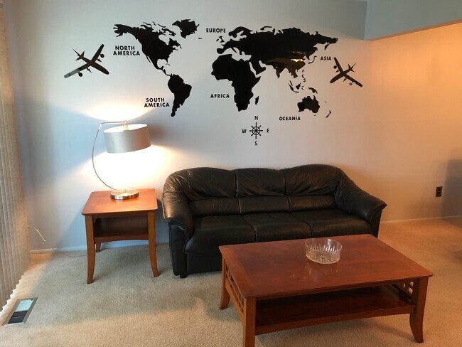 Comfortable living room features leather sofa and coffee table.