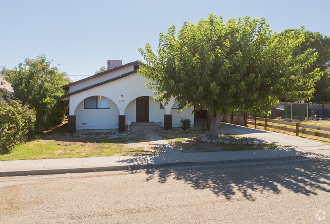Cottages built over the past 120 years in the City of  Dos Palos are shaded by a variety of mature trees.