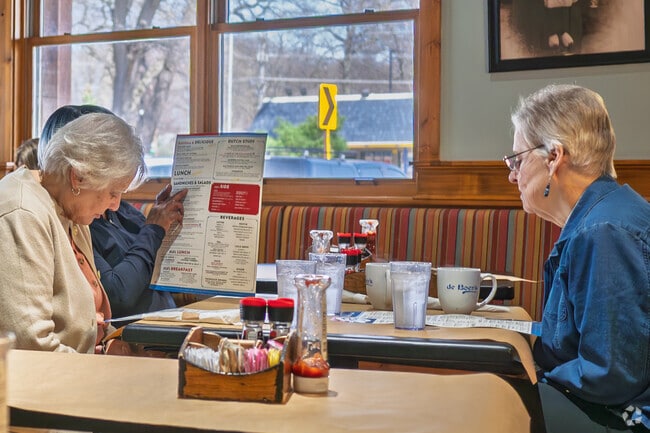 Friends discuss which Dutch treat to order at deBoer's Bakkerij in Beechwood.