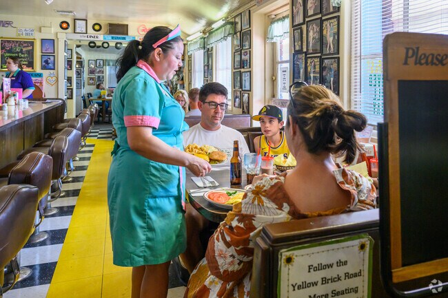 In Peggy Sue's 50's Diner in Yermo, established over a decade earlier, waitresses model Betty Boop's look and walk across checkerboard floors to deliver malt milkshakes and deli sandwiches to booths.