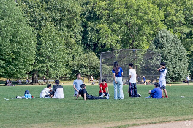 Residents of Little Senegal enjoying a beautiful day in Central Park with friends.