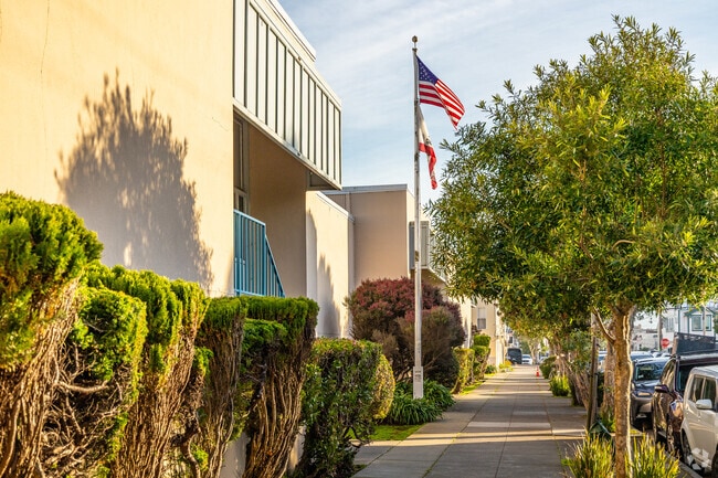 A shady sidewalk fronts Woodrow Wilson Elementary.