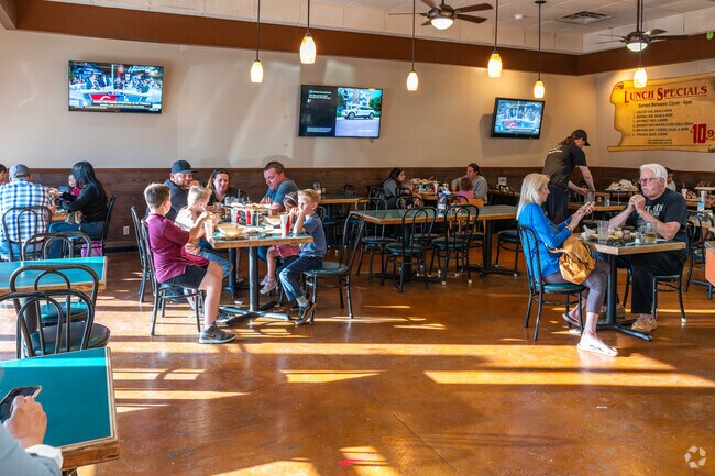 Families enjoying their dinner Friday night at Ameci Pizza in Castaic.