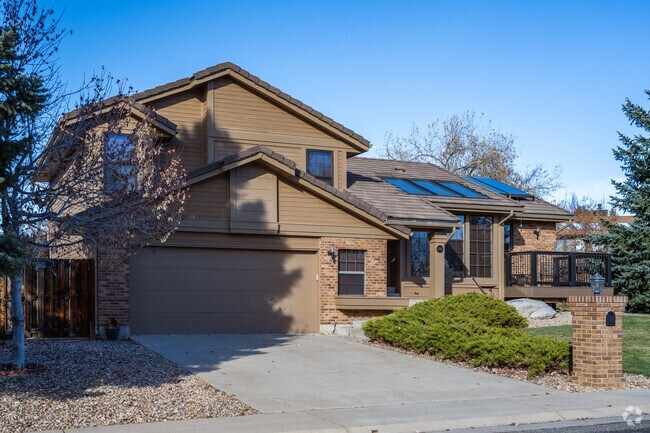 A craftsman home with a lush front yard and a two car garage in Oak Crest South, Arvada, CO.