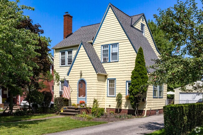 A beautiful Tudor-style home with an arched entry door stands in Wickliffe.