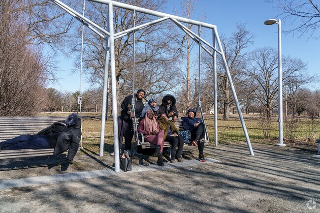 A crew of high school students checks out the new swinging benches in West Parkside.