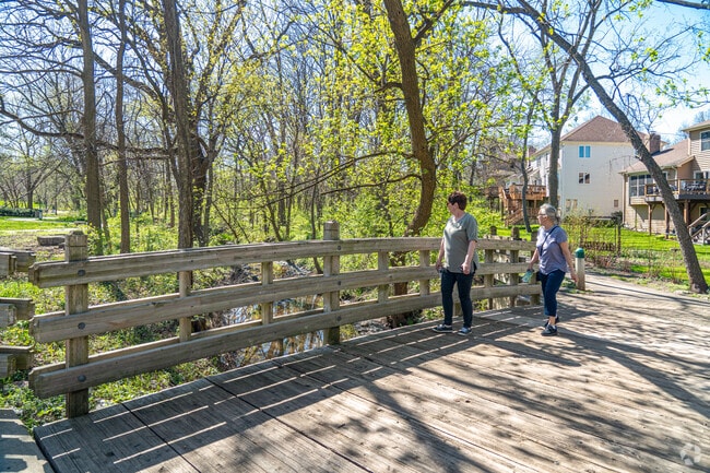 Two residents take in the spring-like weather at the local park in the Seven Bridges community.