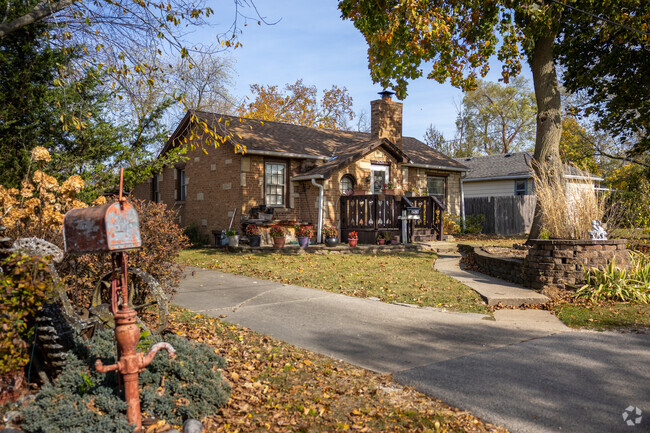 This brick home in Hidden Glen has unique landscaping decorations.