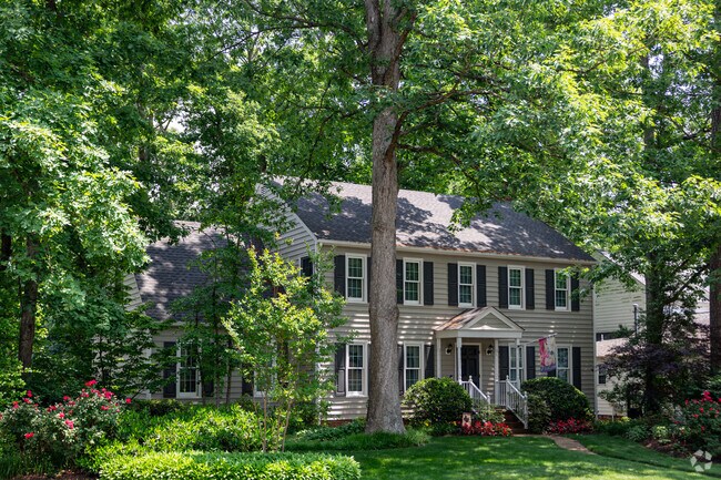 A beautifully landscaped yard lends additional appeal to this colonial style home in Innsbrook.