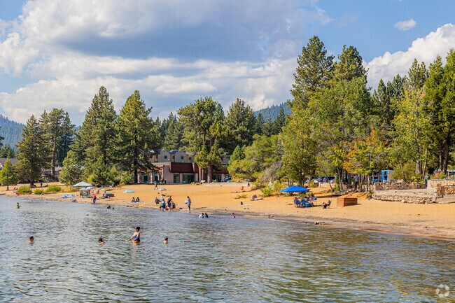 People enjoy the cool waters of Lake Tahoe at Kings Beach State Park.