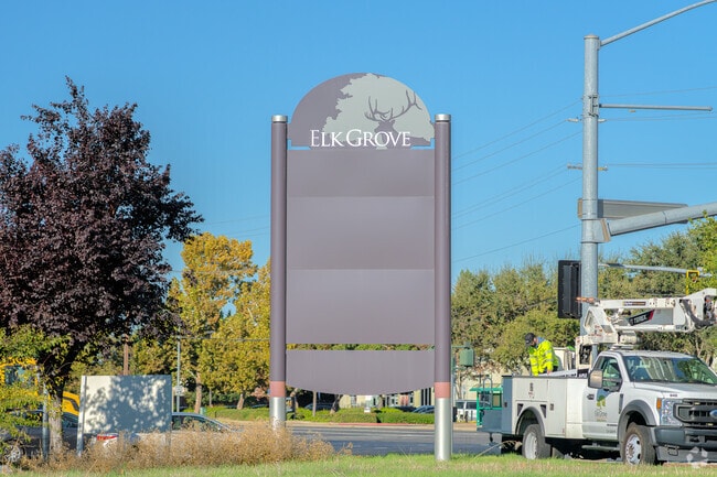 City worker changes displays on the North West Elk Grove sign.