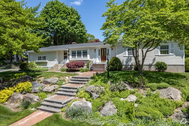 A ranch style home can have layers of landscaping that dazzle the eye in the Cowesett neighborhood.