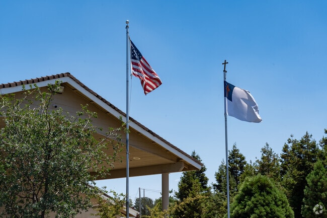 Flags fly high in front of Heritage Oak School.
