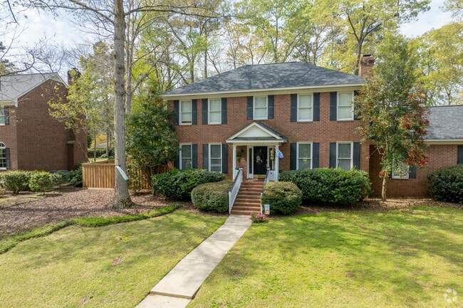 This Colonial-style home stands majestically on this wooded lot in Martinez.