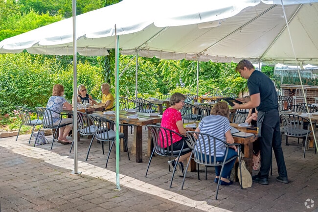 Stanhope locals savor good food and better company on Bell Mansion's lush, garden-lined patio.