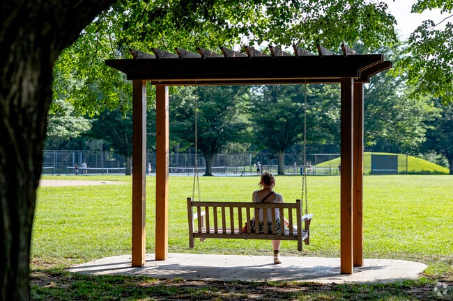 A shaded swing set on the north end of Burns Park is the perfect spot for quiet contemplation.