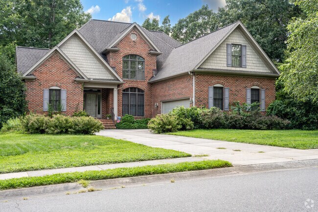 Certain residential areas in Mebane feature two-story brick homes with tree-lined streets.