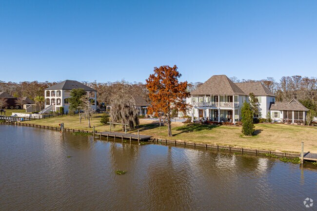 Large homes sit on the waterfront of the Amite River in At Amant.