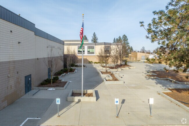 Garry Middle School has a tall flag pole near the parking lot.