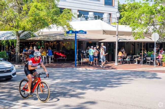Catch people outside doing various activities all throughout the day in Southwest Coconut Grove.