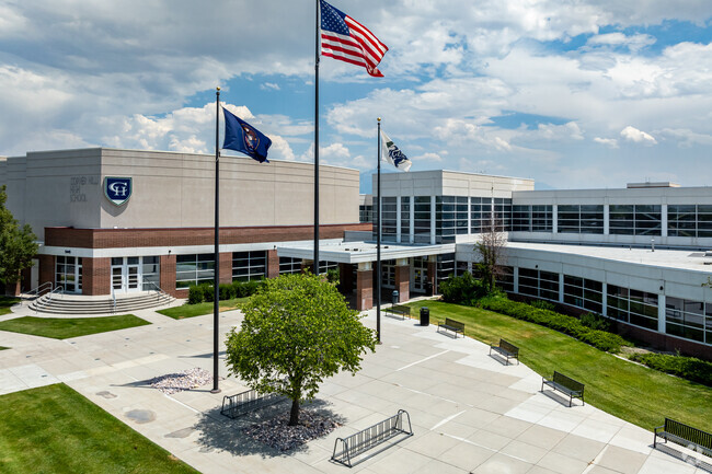 Flags wave in front of Copper Hills High School.