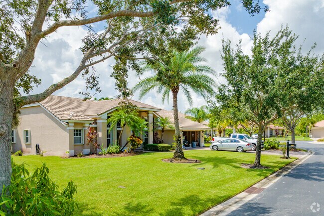 Row of single family homes in Sawgrass Lakes with lush landscaping.