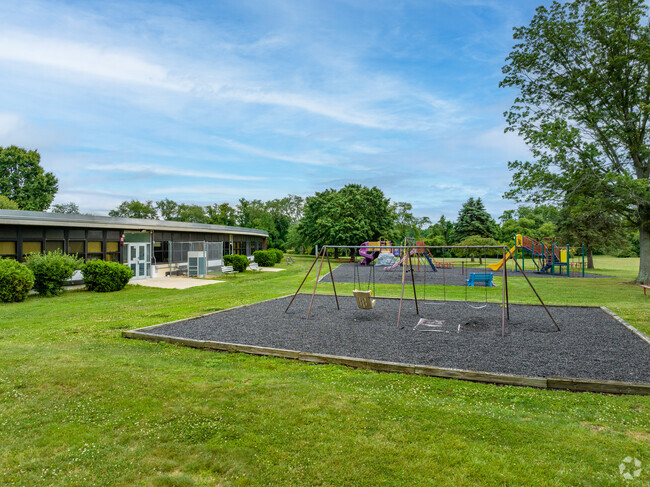 The play area at Edith M. Griebling Elementary School is in a park like setting.